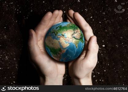 With love and care to our planet. Human hands holding in palms Earth palnet. Elements of this image furnished by NASA