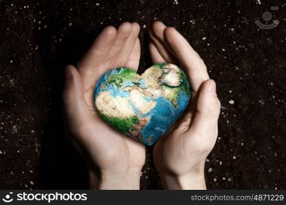 With love and care to our planet. Human hands holding in palms Earth palnet. Elements of this image furnished by NASA