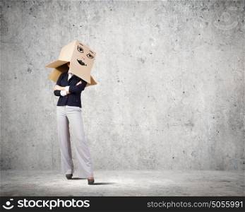 With mask on face. Conceptual image of businesswoman with carton box on head