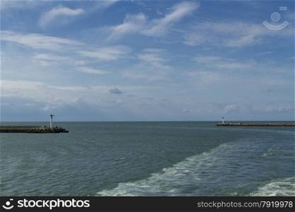 With wash from ferry, entrance to Dunkirk Harbor, France, Europe.