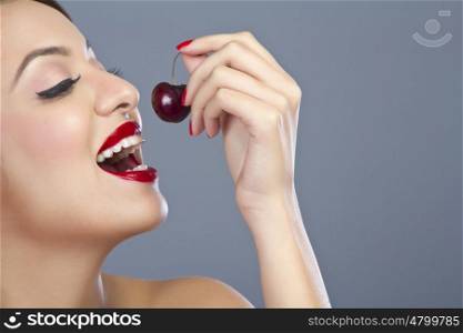 Woman about to eat a cherry