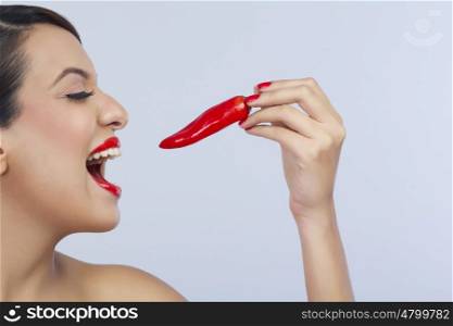 Woman about to eat a chilli