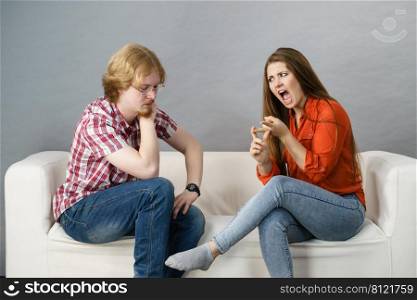 Woman accusing man. Couple having relationship problems, female being mean and rude, bored guy listening to her.. Couple having problems