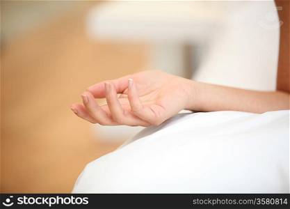 Woman&acute;s arm resting on a bed