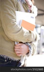 Woman&acute;s arms holding notebooks