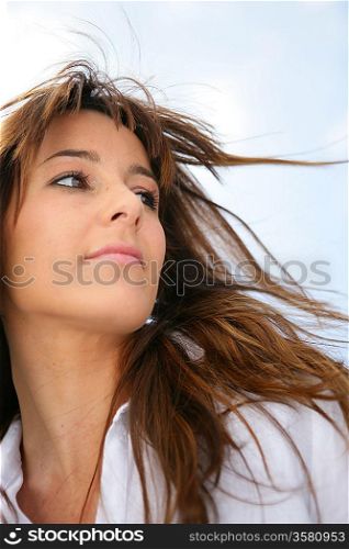 Woman&acute;s hair blowing in the breeze