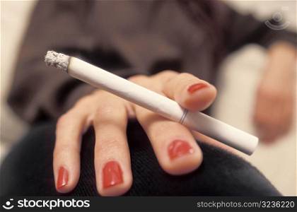 Woman&acute;s Hand Holding a Cigarette