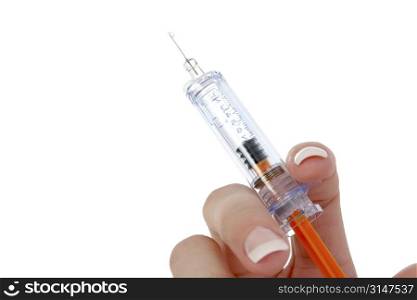 Woman&acute;s hand holding syringe. Drop at end of needle.