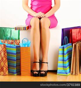 Woman&acute;s legs and shopping bags