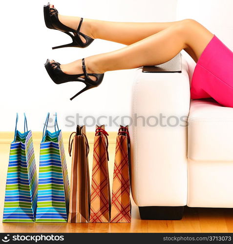 Woman&acute;s legs and shopping bags