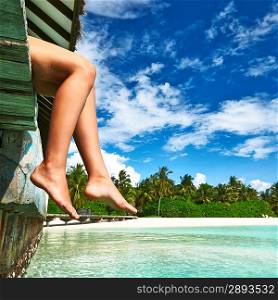 Woman&acute;s legs at beach jetty