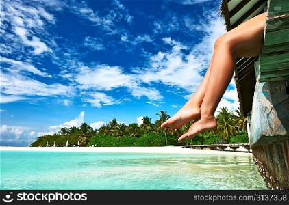 Woman&acute;s legs at beach jetty