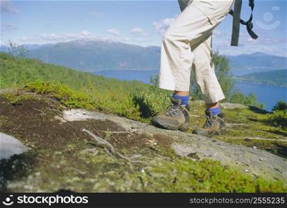 Woman&acute;s legs hiking outdoors in scenic location