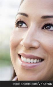 Woman&acute;s smiling face outdoors (selective focus)