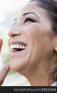 Woman&acute;s smiling face outdoors (selective focus)