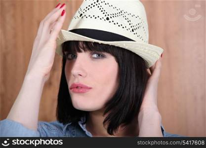 Woman adjusting her hat
