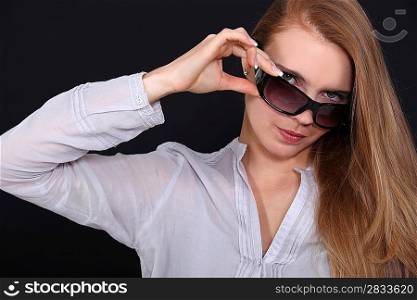 Woman adjusting her sunglasses