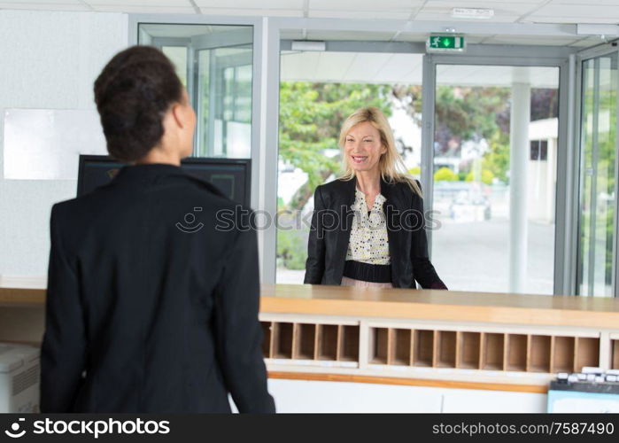 woman administrator and the client on the visitor reception