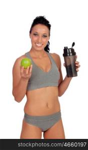Woman after her training, drinking protein shake and with an apple in hand