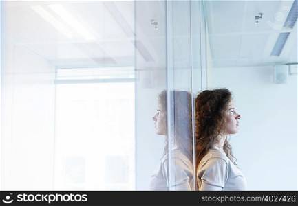 Woman against window, thinking
