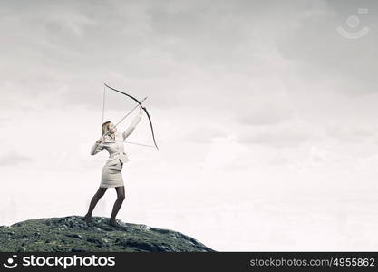 Woman aiming her goal. Young businesswoman aiming with archer to make shot