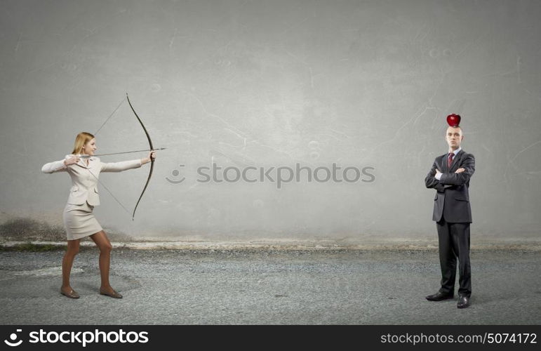 Woman aiming her goal. Young businesswoman aiming with archer to make shot