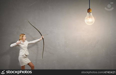 Woman aiming her goal. Young woman archer in suit aiming to idea bulb