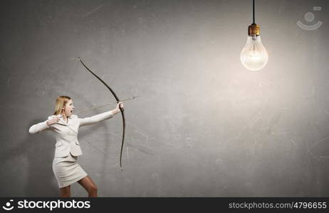 Woman aiming her goal. Young woman archer in suit aiming to idea bulb