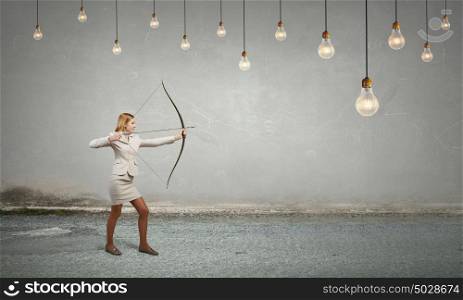 Woman aiming her goal. Young woman archer in suit aiming to idea bulb