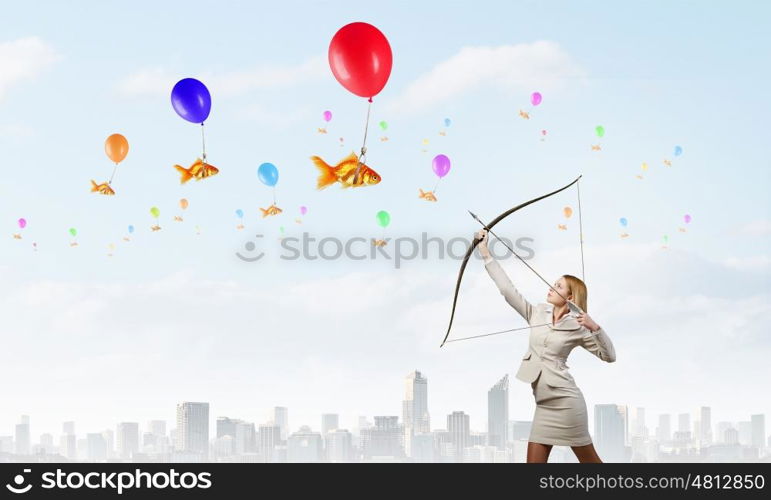 Woman aiming her goal. Young woman archer in suit aiming to make shoot