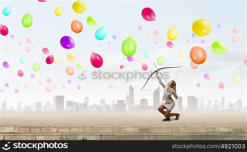Woman aiming her goal. Young woman archer in suit aiming to make shoot