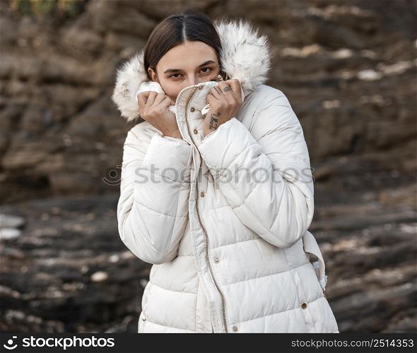 woman alone beach with winter jacket