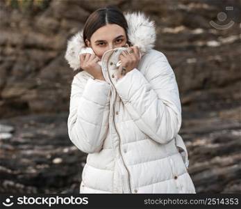 woman alone beach with winter jacket