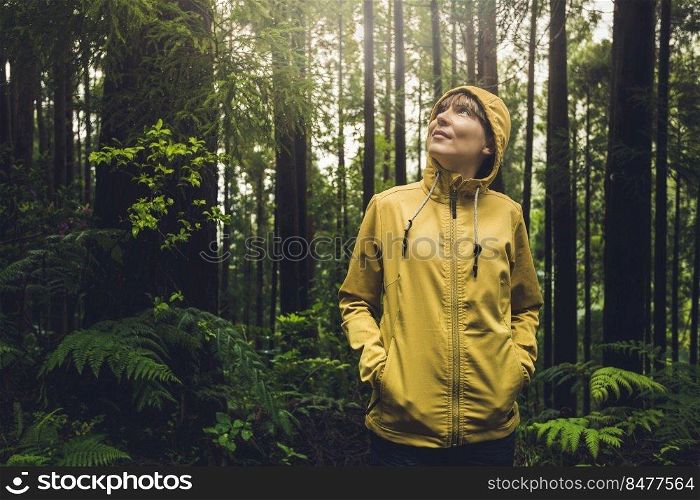 Woman alone in the forest enjoying the nature