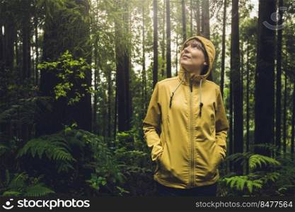 Woman alone in the forest enjoying the nature