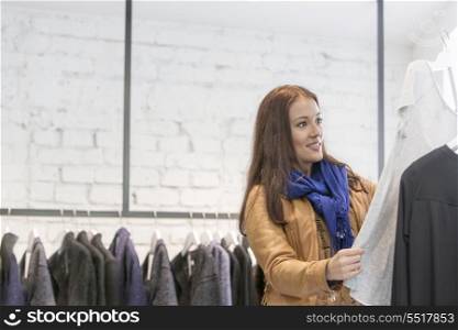 Woman analyzing top in store