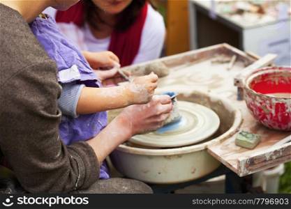 woman and child in a potter&rsquo;s wheel