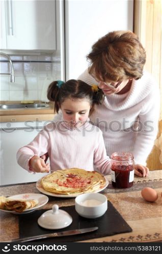 Woman and child making pancakes