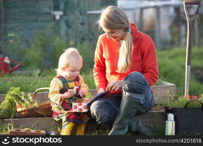 Woman and child with picnic on allotment
