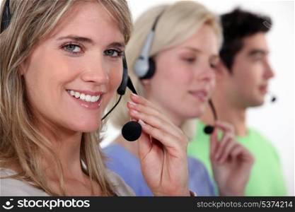 Woman and colleagues wearing headsets