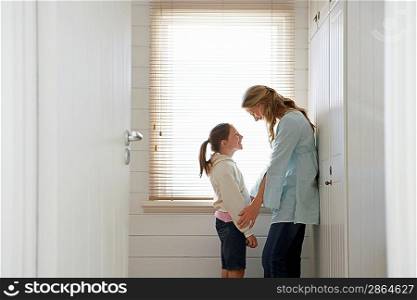 Woman and Daughter By Window