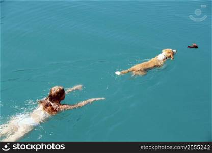 Woman and dog outdoors swimming in lake