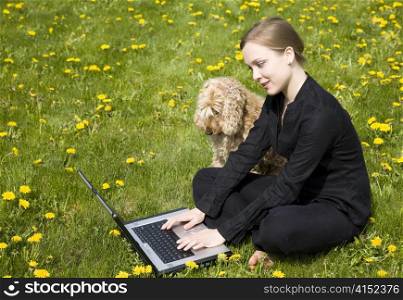 Woman And Dog Working Outdoors