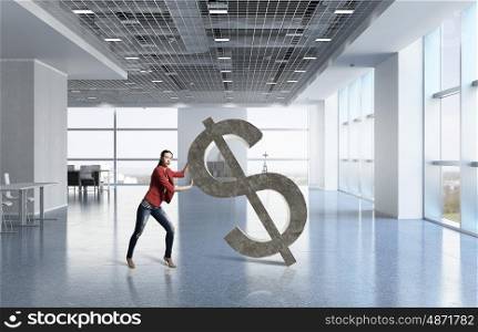 Woman and dollar currency sign. Young woman in modern interior pushing dollar symbol