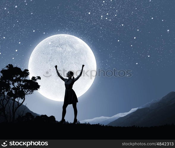 Woman and full moon. Silhouette of woman on hill at night