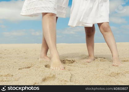 Woman and her little daughter on the beach