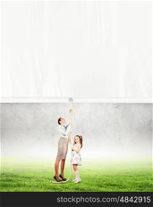 Woman and little girl pulling banner. Woman and little girl pulling banner. Place for text