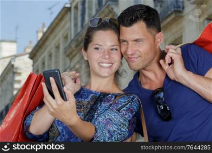 woman and man are taking selfie after shopping together