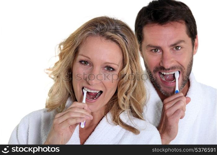 woman and man brushing teeth