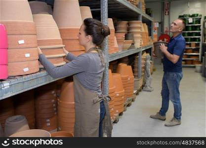 woman and man choosing unpainted vase in atelier